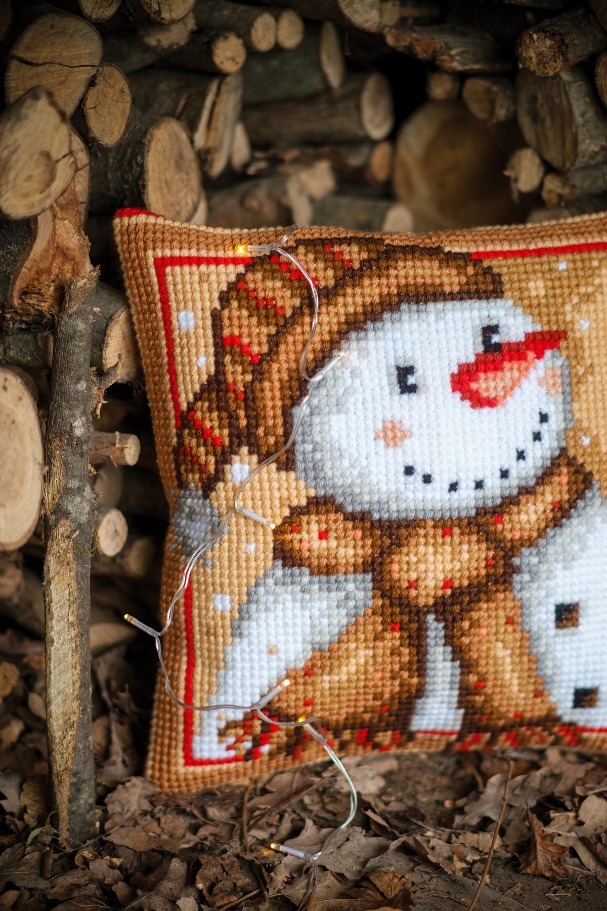 Cross stitch cushion with a snowman