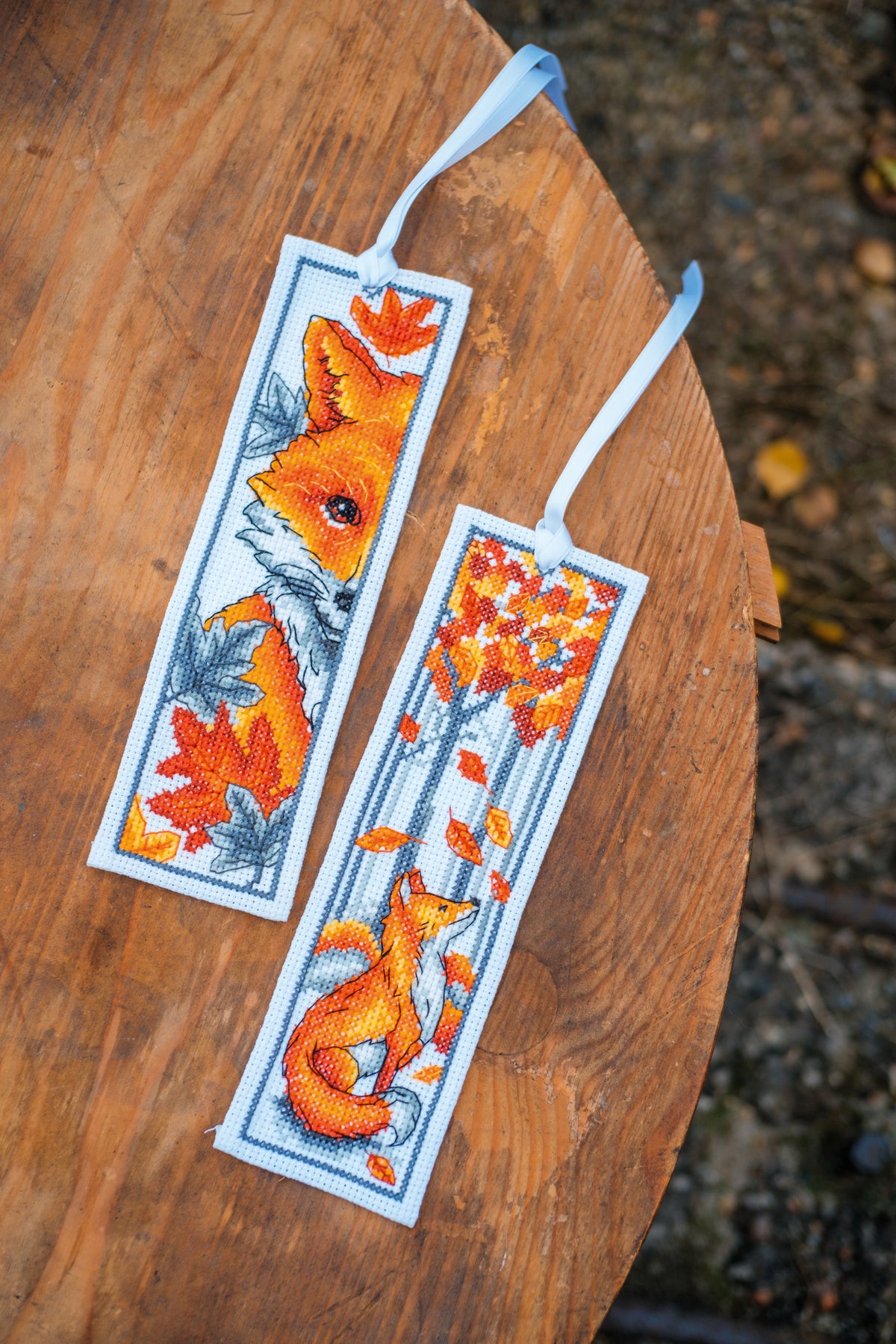 Two cross stitched bookmarks with fox designs