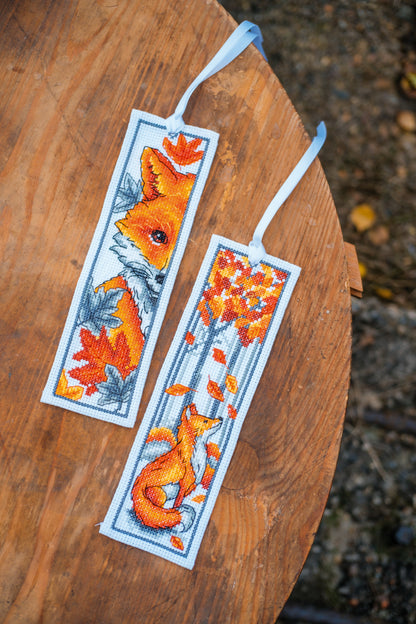 Two cross stitched bookmarks with fox designs
