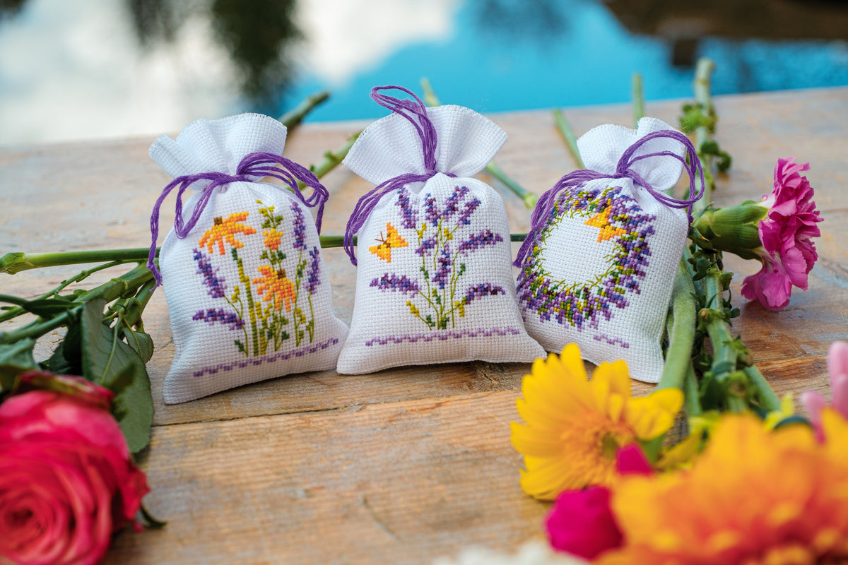 Three small cross stitch bags with lavender designs