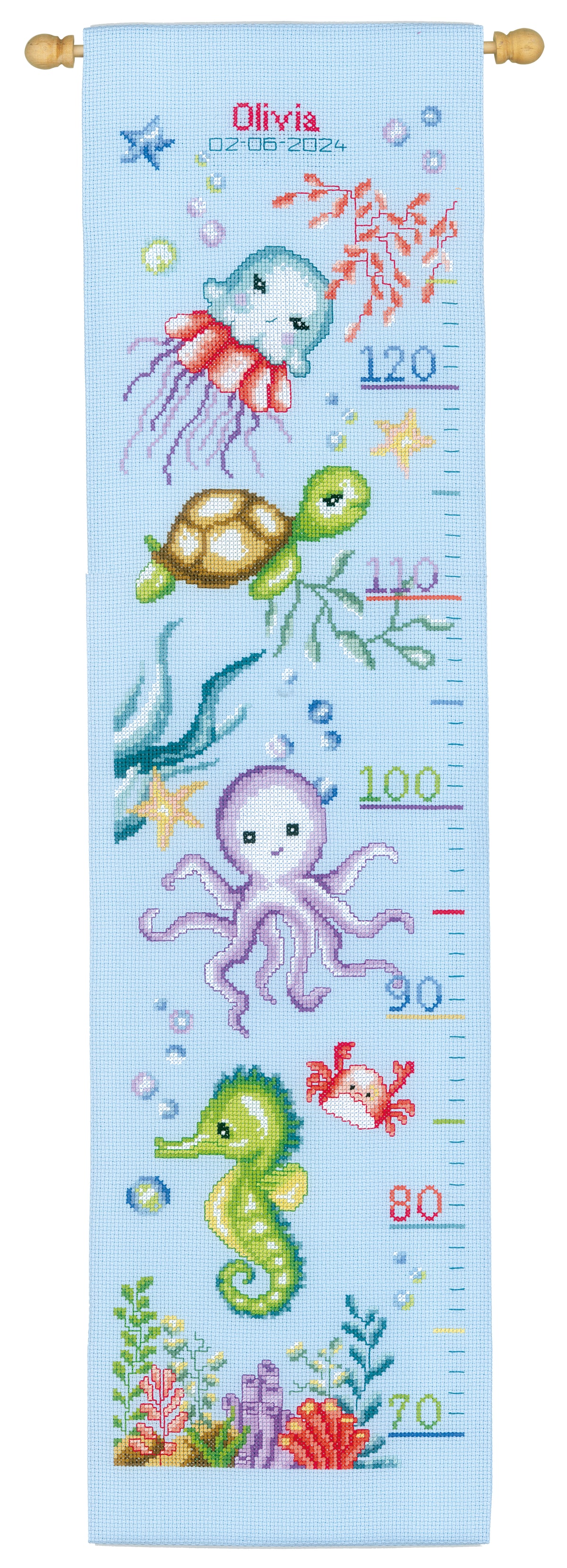 Cross stitched height chart with sea animals on light blue fabric