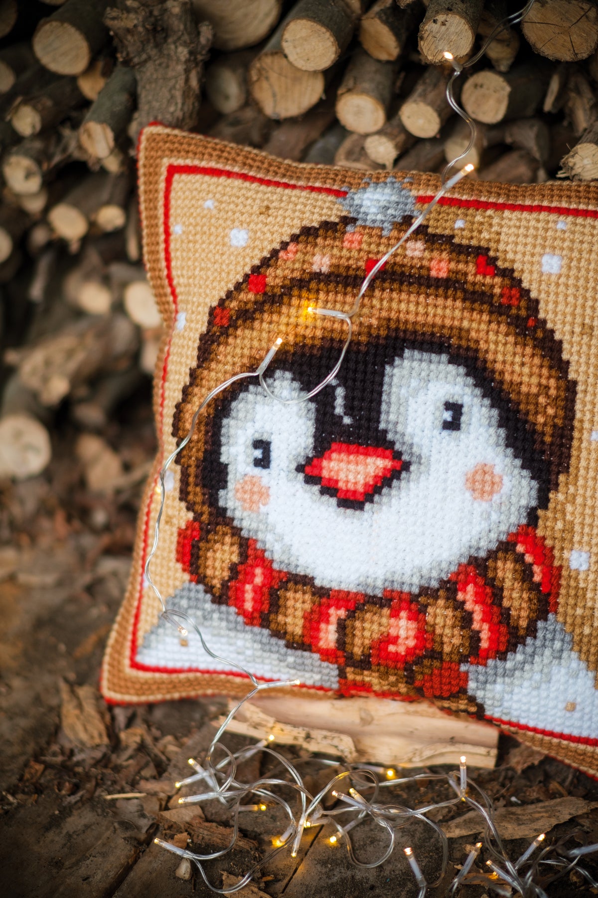 Cross stitch cushion with a penguin