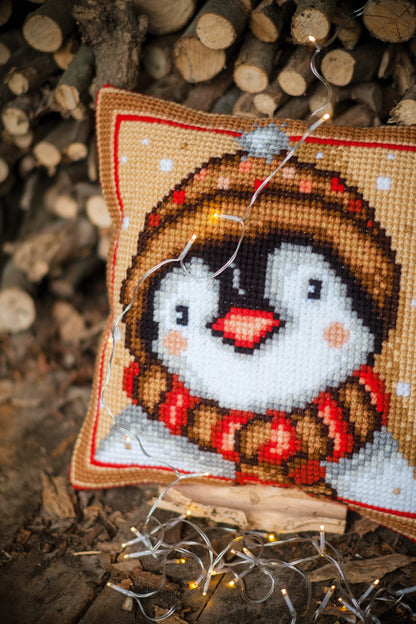 Cross stitch cushion with a penguin