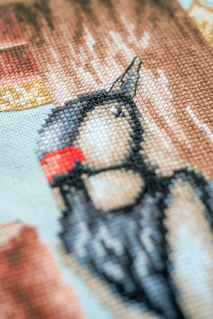 Cross stitch of a busy neighbourhood street scene