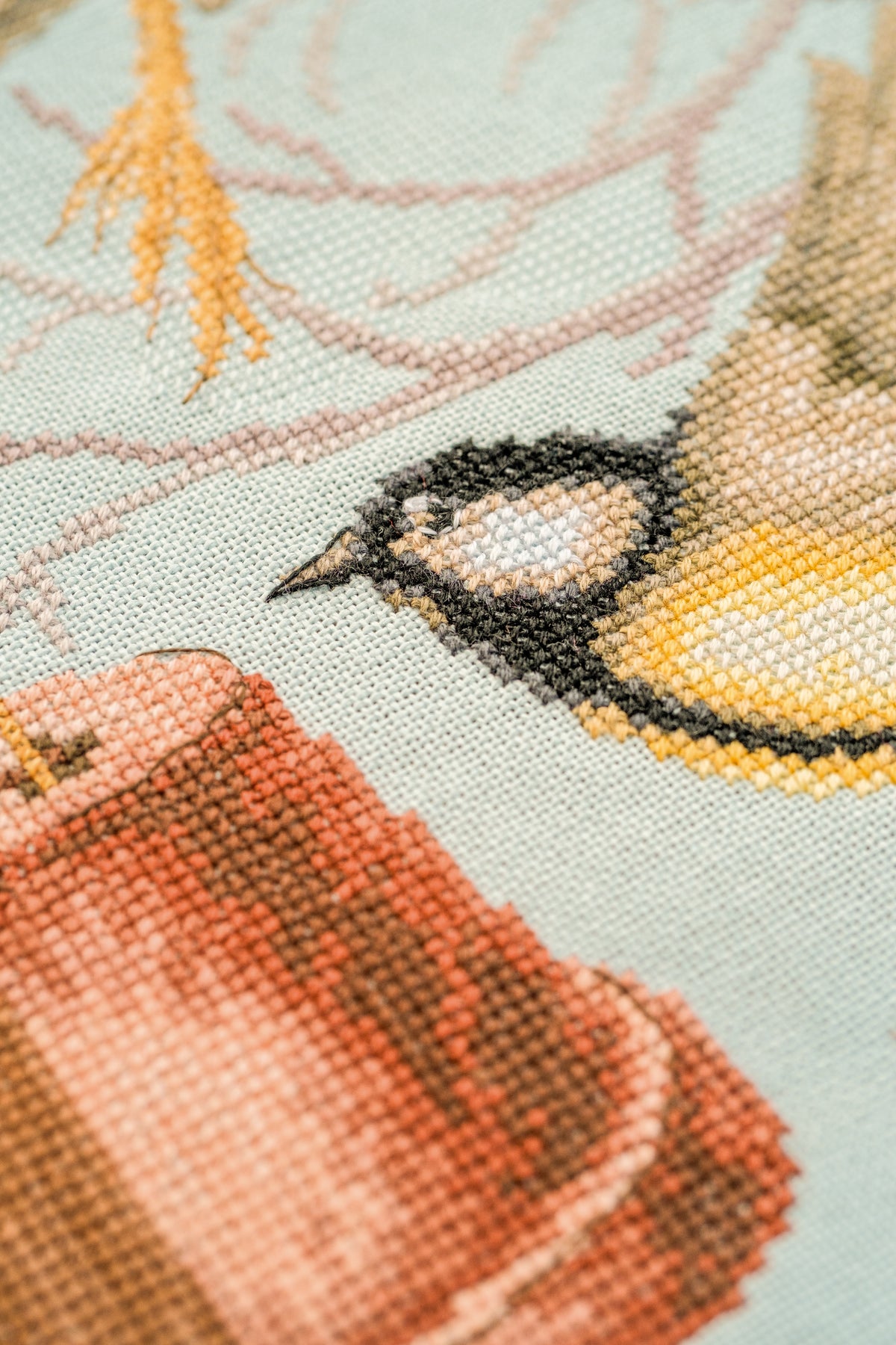 Cross stitch of a busy neighbourhood street scene