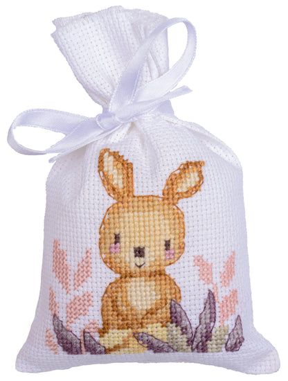 Three cross stitched woodland gift bags tied with ribbon