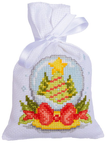 Three cross stitched Christmas gift bags tied with ribbon