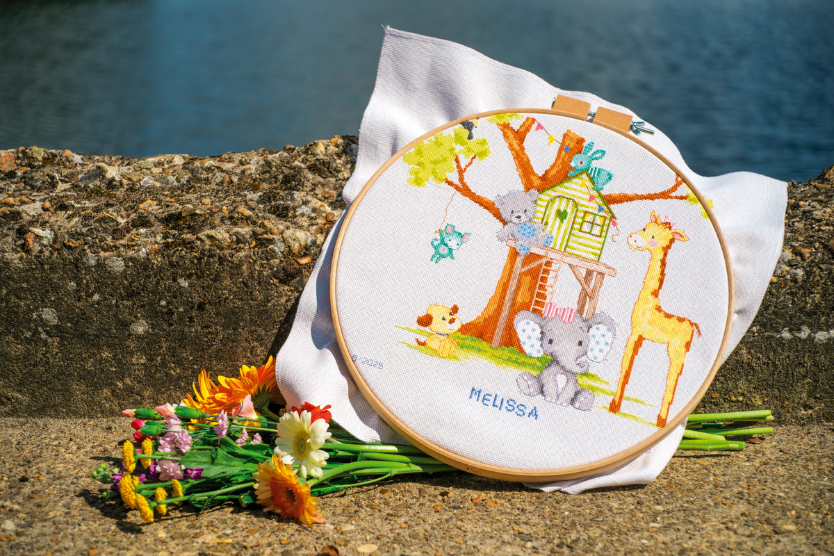 Vervaco At the Tree House Birth Record counted cross stitch kit showing the finished design