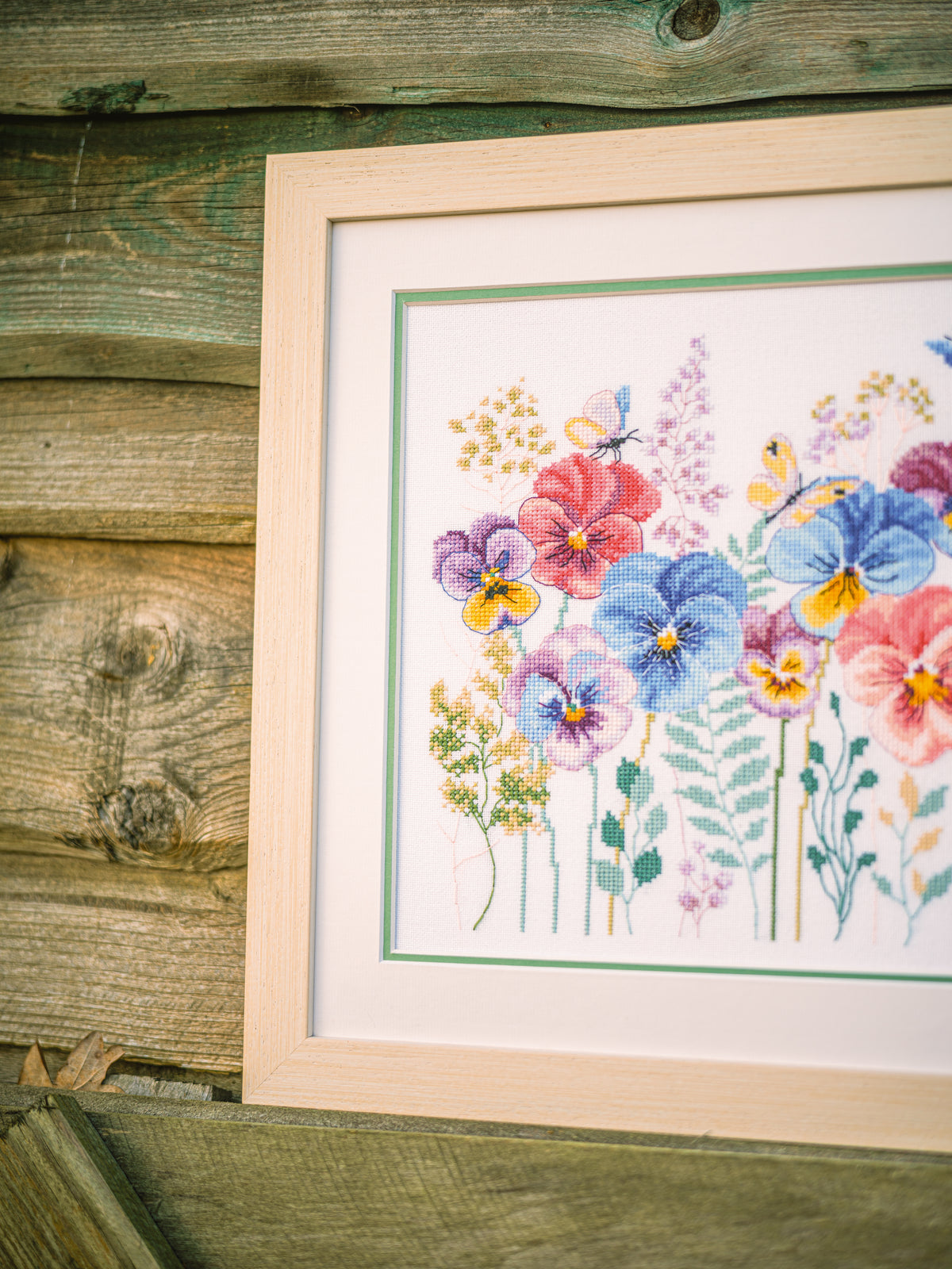 Cross stitch picture of pansies and grasses