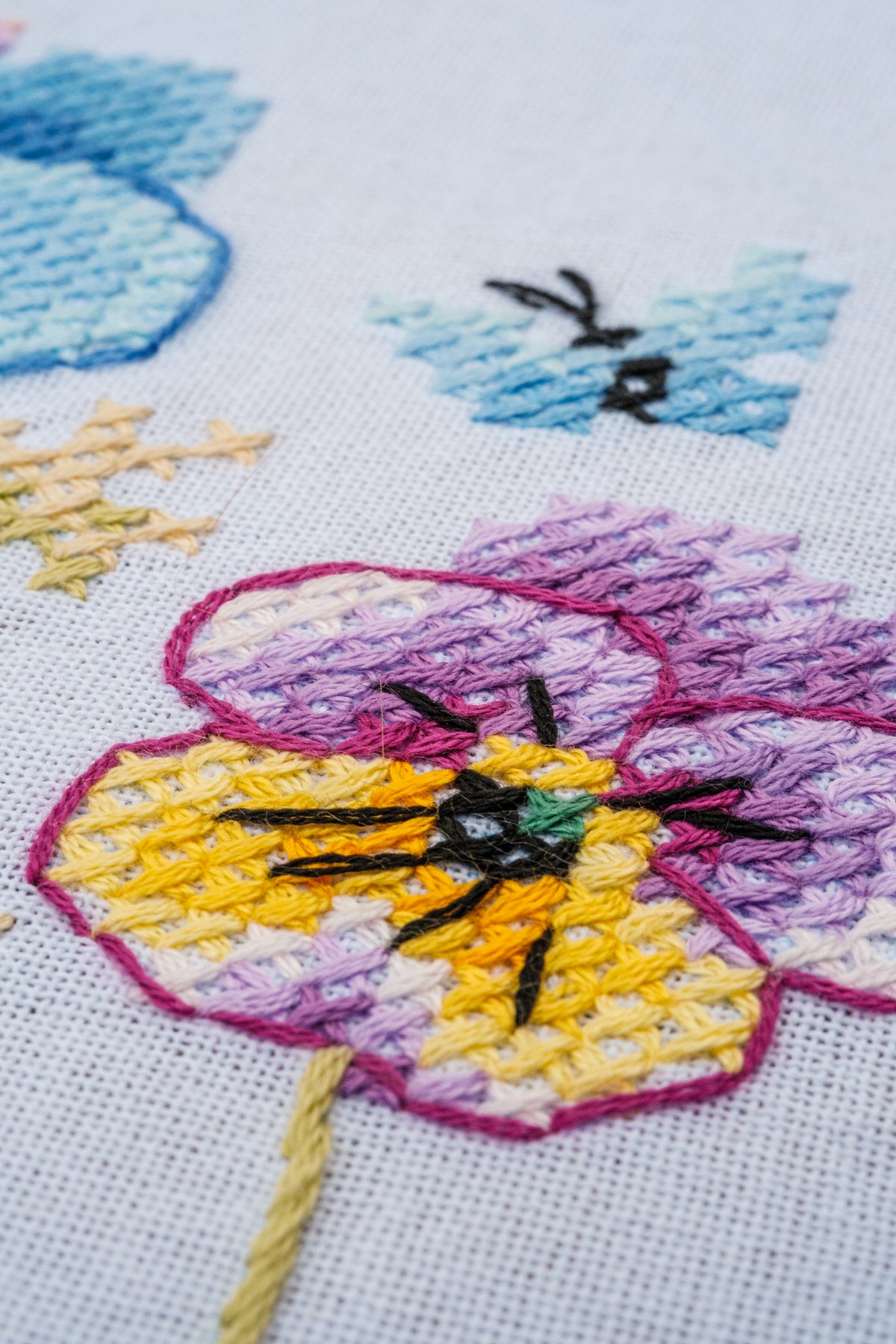 Vervaco Violets embroidered tablecloth kit showing the finished piece