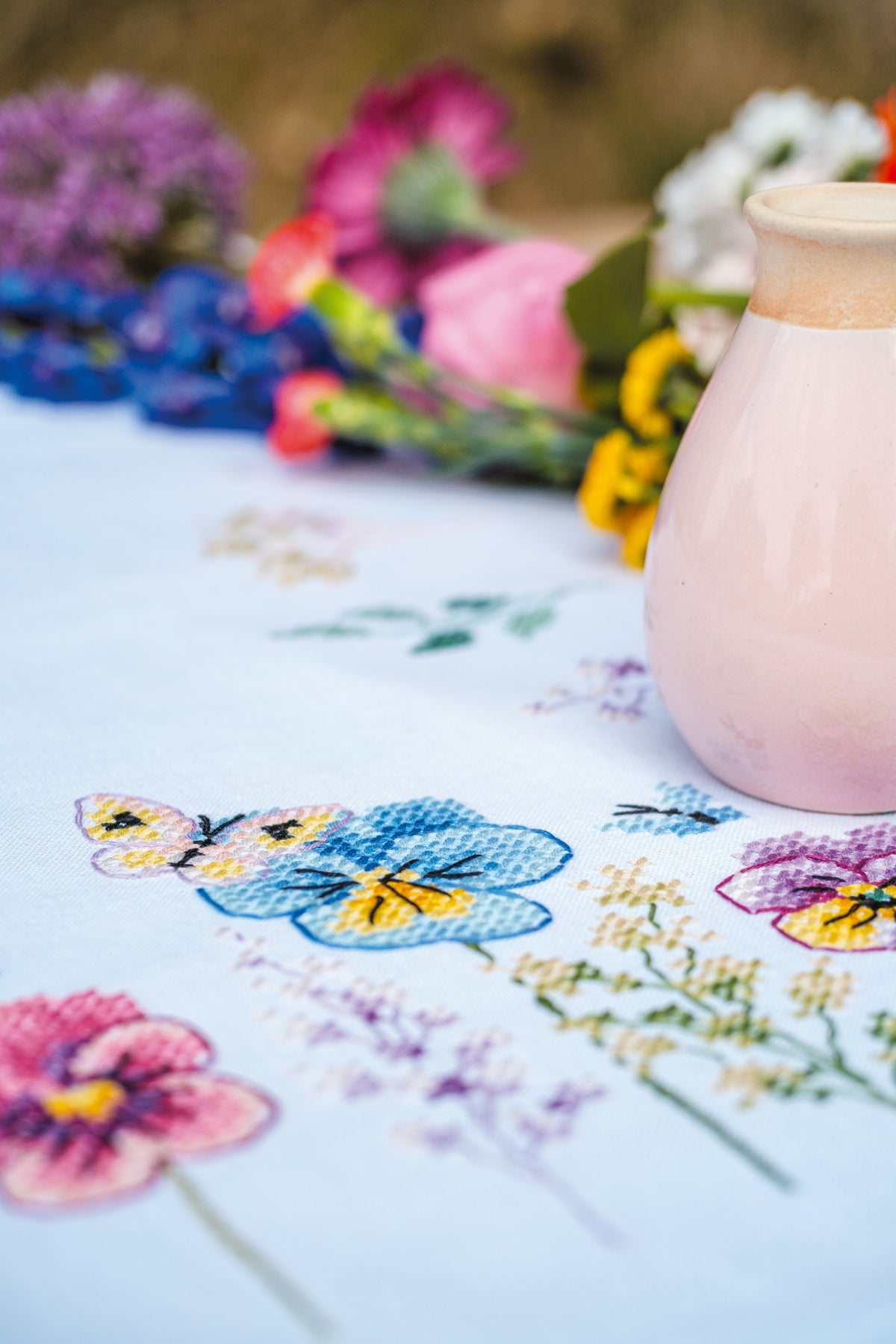 Vervaco Violets embroidered table runner kit showing the finished piece