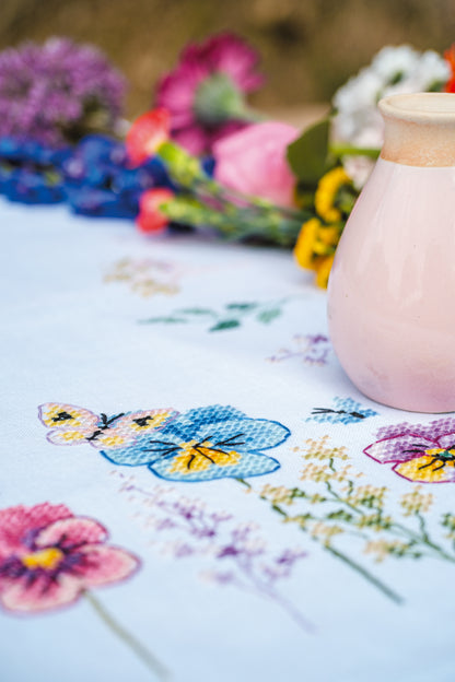 Vervaco Violets embroidered table runner kit showing the finished piece