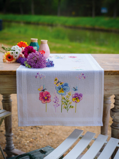 Vervaco Violets embroidered table runner kit showing the finished piece