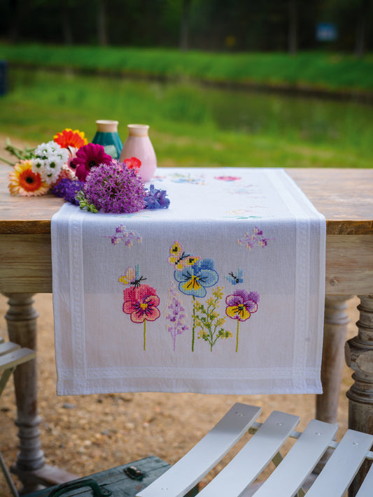 Vervaco Violets embroidered table runner kit showing the finished piece