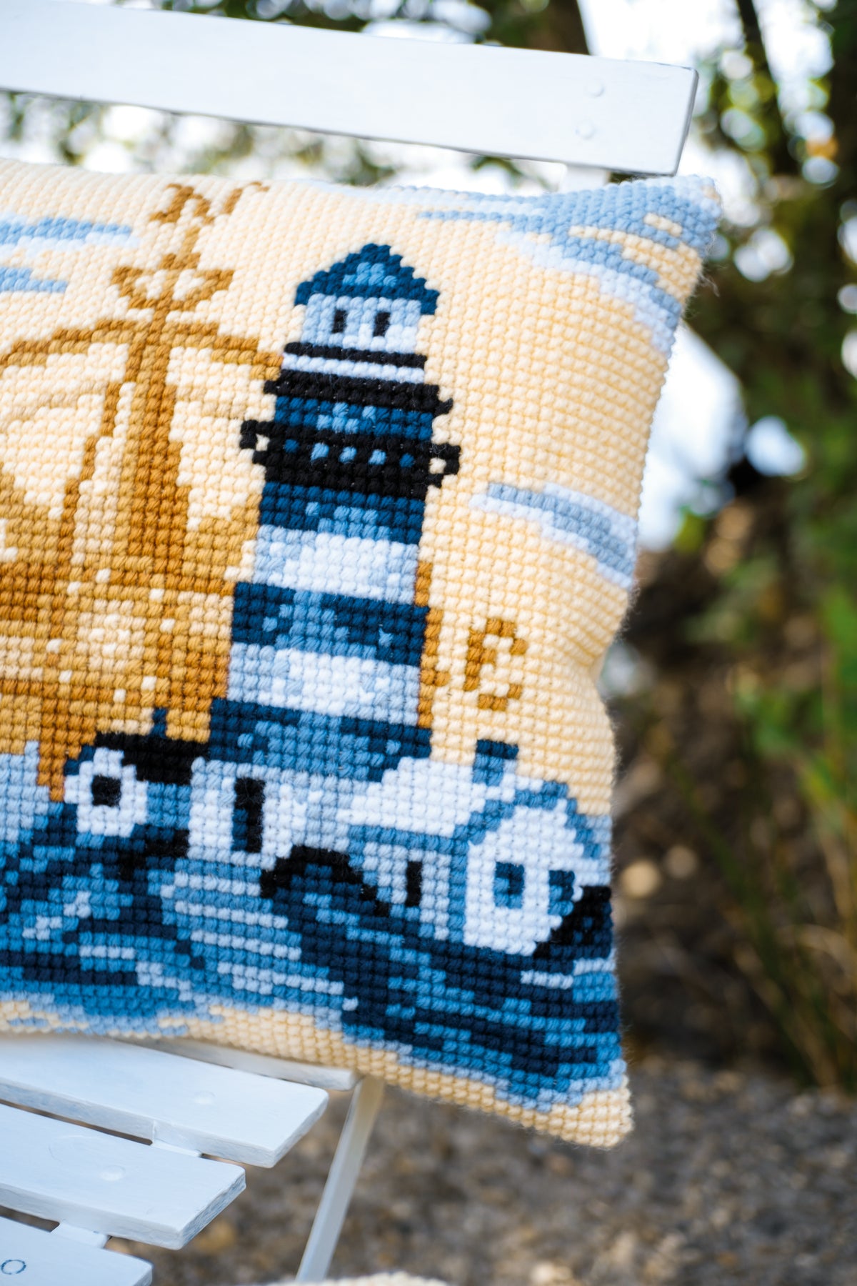 Vervaco Navy cross stitch cushion kit showing the finished cushion