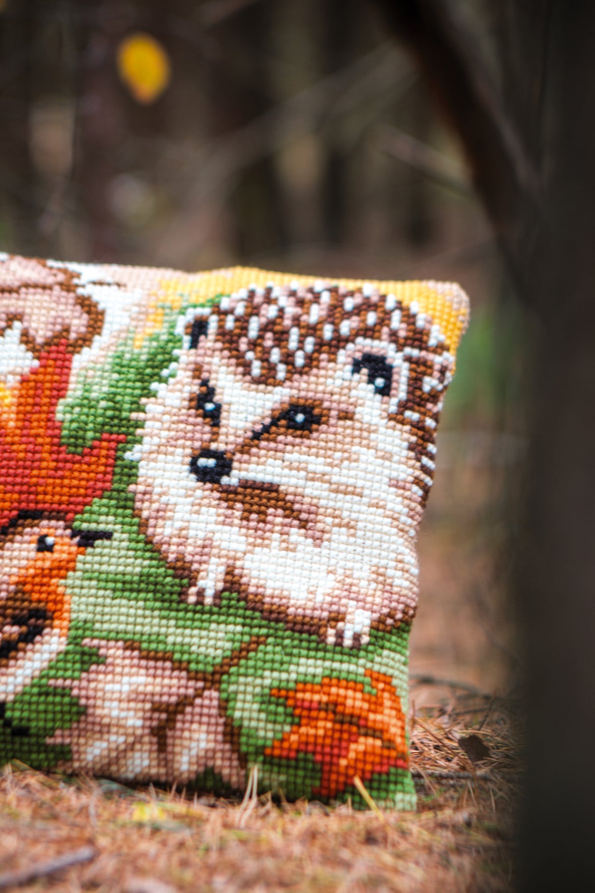 Vervaco Hedgehog and Robin cross stitch cushion kit showing the finished cushion