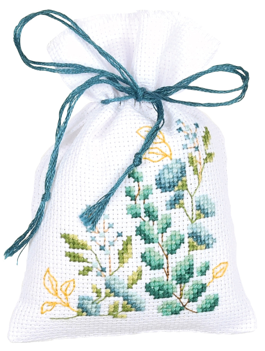 Three small white gift bags cross stitched with nature motifs