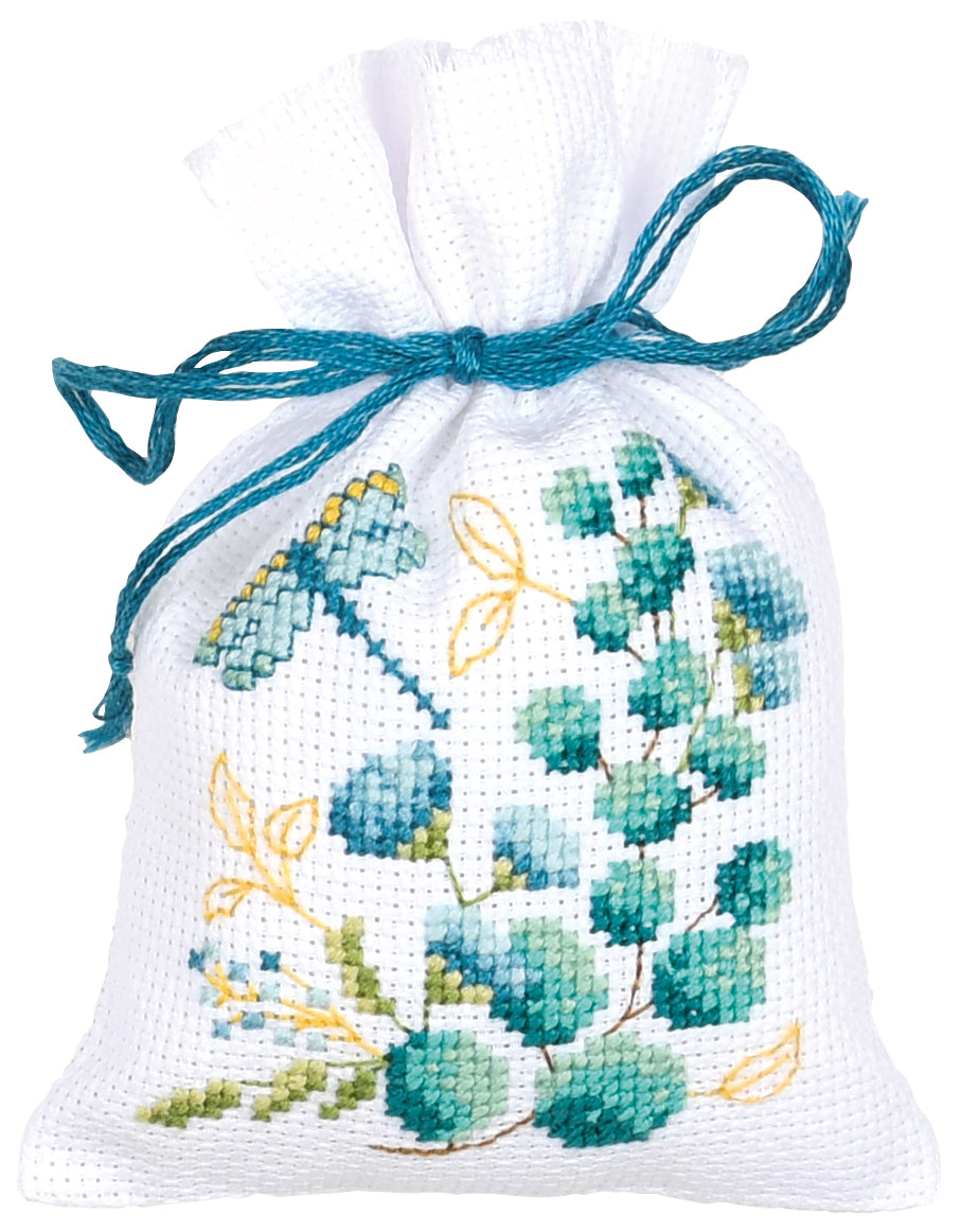 Three small white gift bags cross stitched with nature motifs