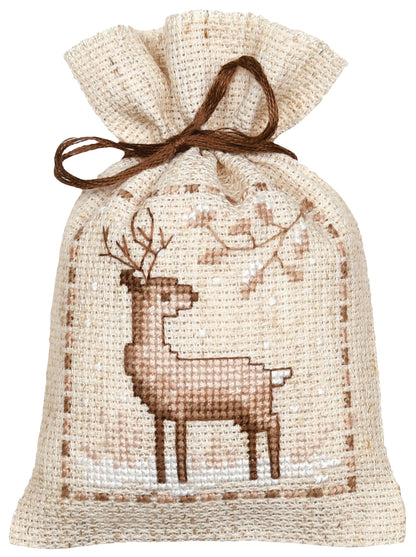 Three natural linen gift bags cross stitched with winter animals