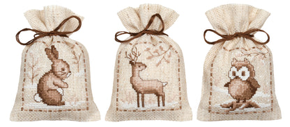 Three natural linen gift bags cross stitched with winter animals