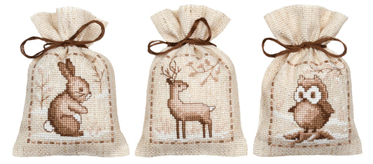 Three natural linen gift bags cross stitched with winter animals