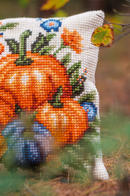 Square cushion cross stitched with orange pumpkins