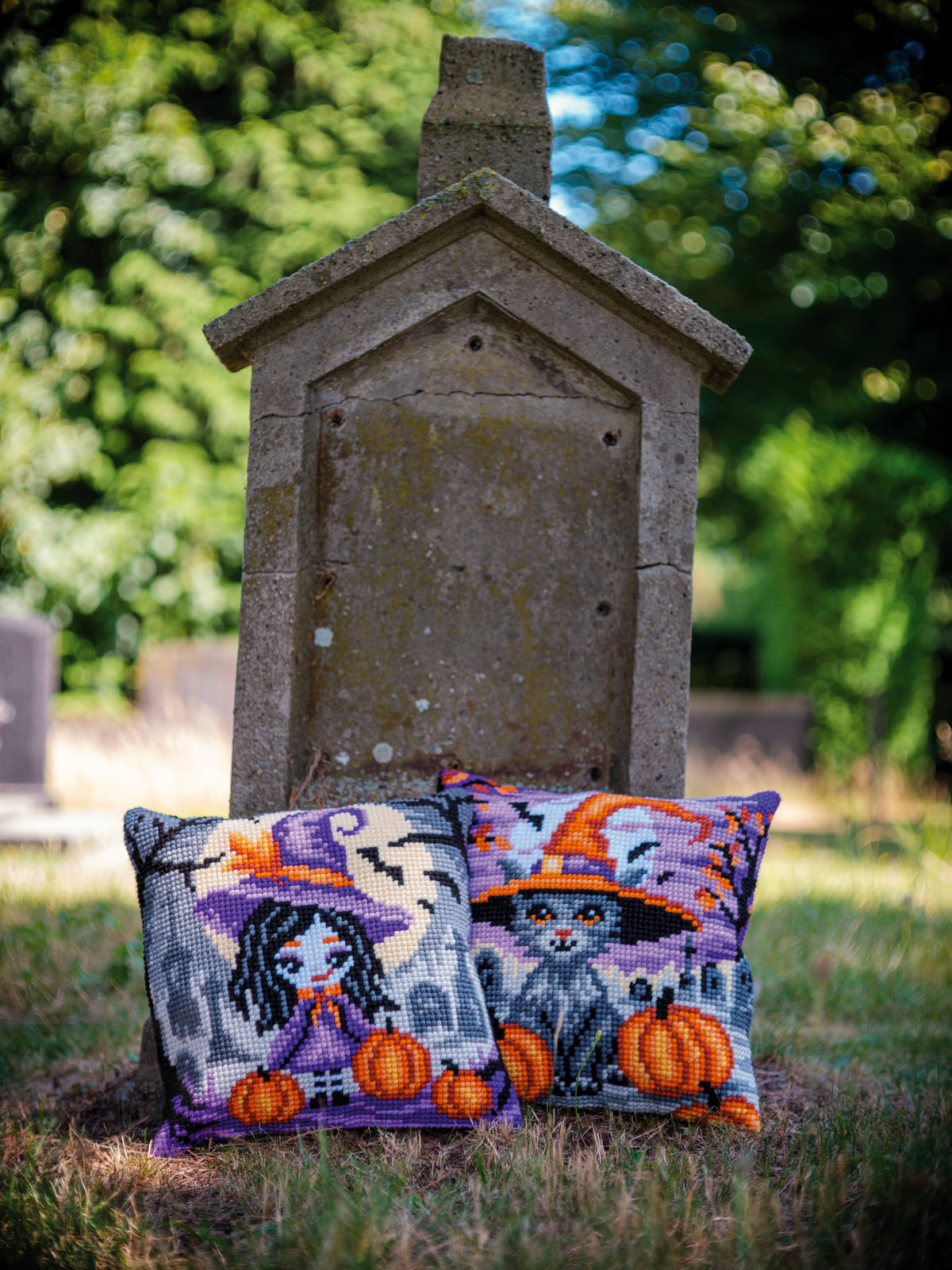 Square cushion cross stitched with a girl in a Halloween costume