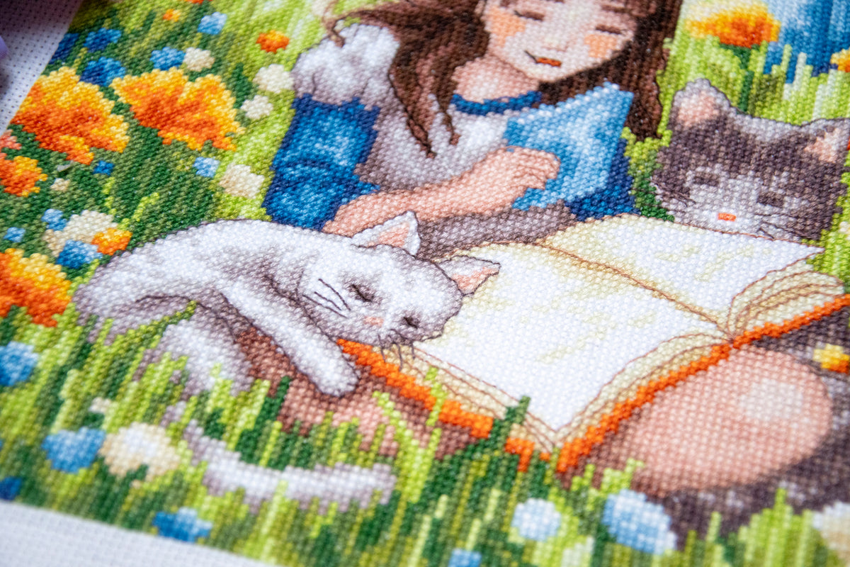 Cross stitch picture of a relaxing garden scene