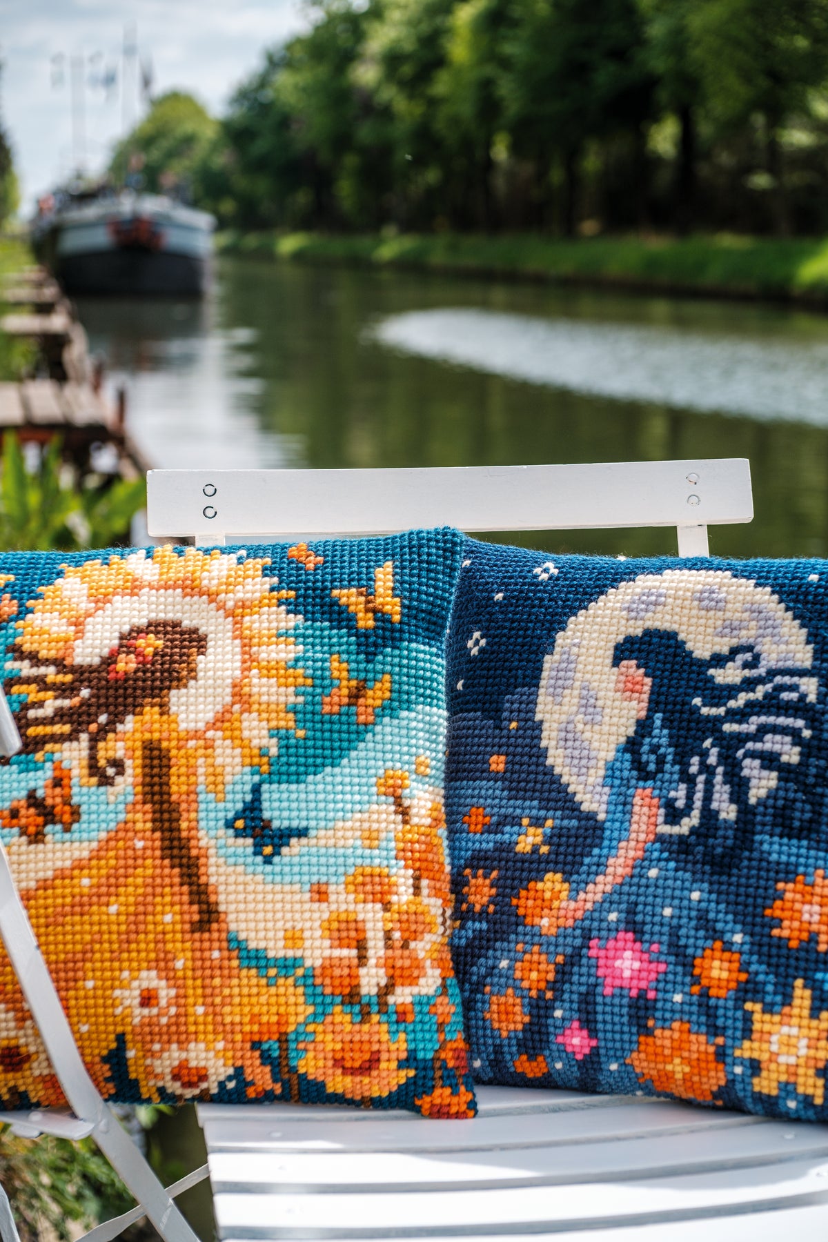 Square cushion cross stitched with a girl and the sun