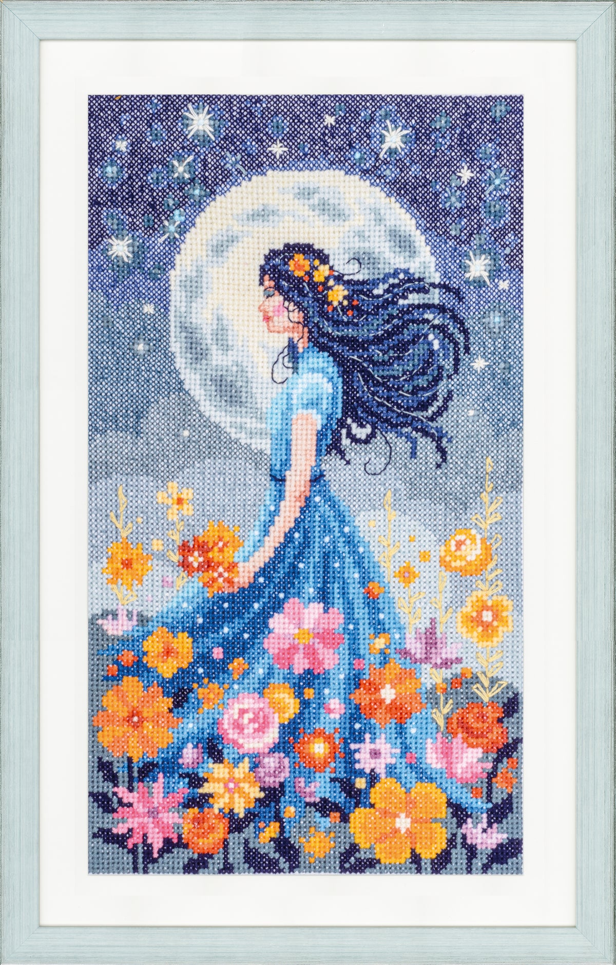 Cross stitch picture of a girl with the moon