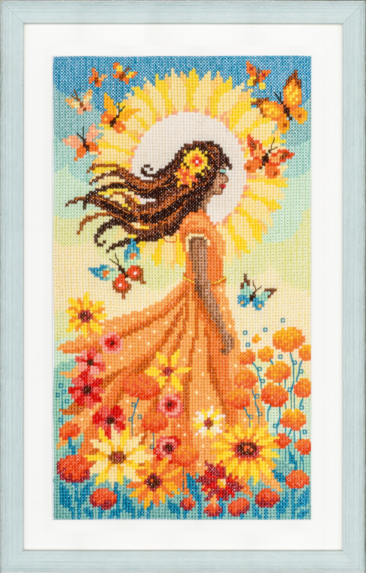Cross stitch picture of a girl with the sun