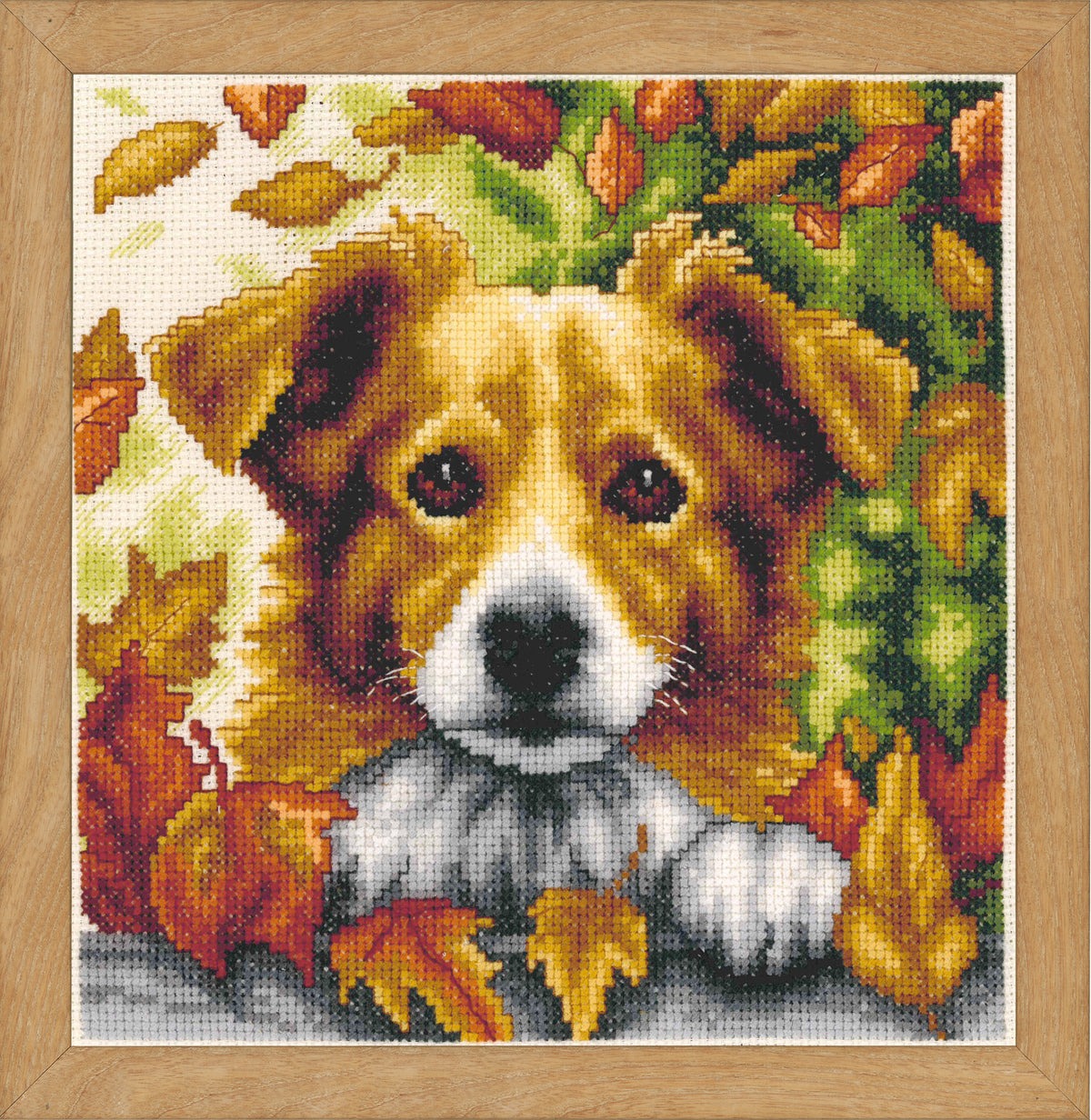Cross stitch picture of a dog among autumn leaves
