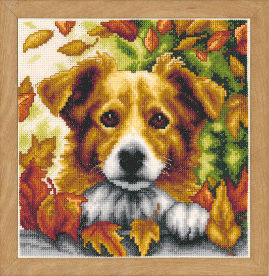 Cross stitch picture of a dog among autumn leaves