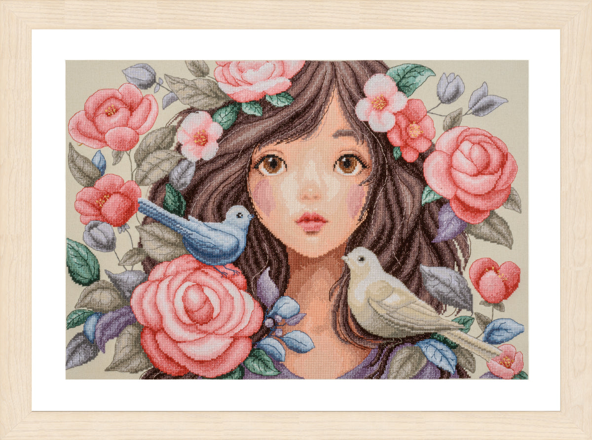 Cross stitch picture of a woman surrounded by roses