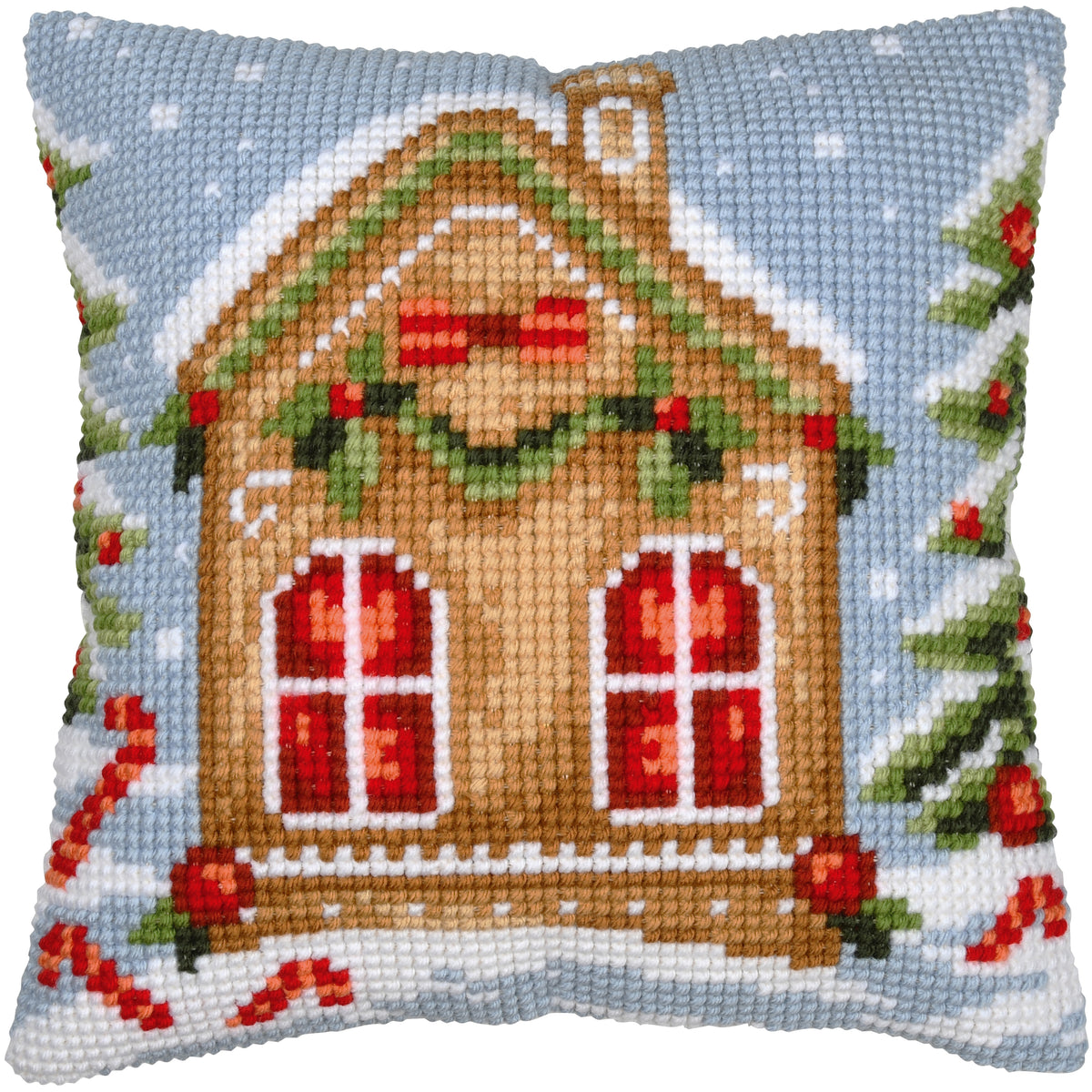 Square cushion cross stitched with a gingerbread house