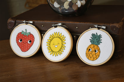 Eva Mouton sunflower cross stitch design in an embroidery hoop