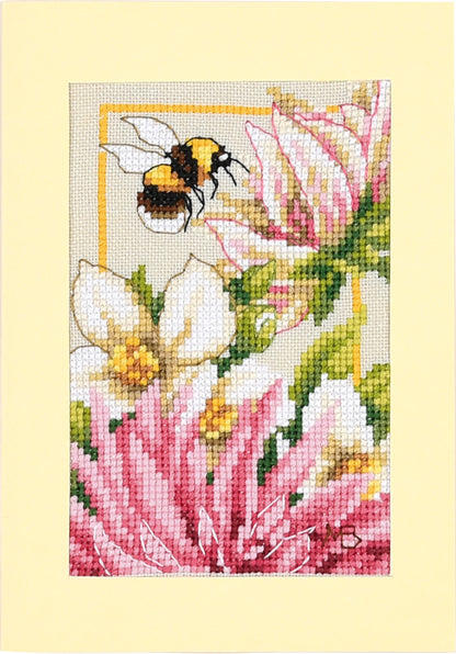 Three cross stitched greetings cards with pink dahlia flowers