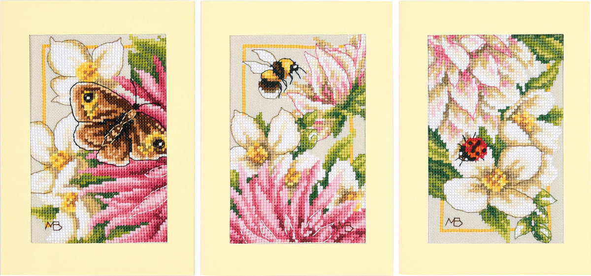 Three cross stitched greetings cards with pink dahlia flowers