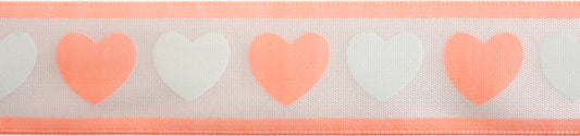 Reel of white ribbon printed with baby pink and green hearts