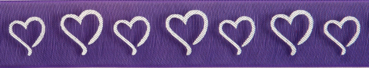 Reel of white on purple ribbon printed with curly hearts