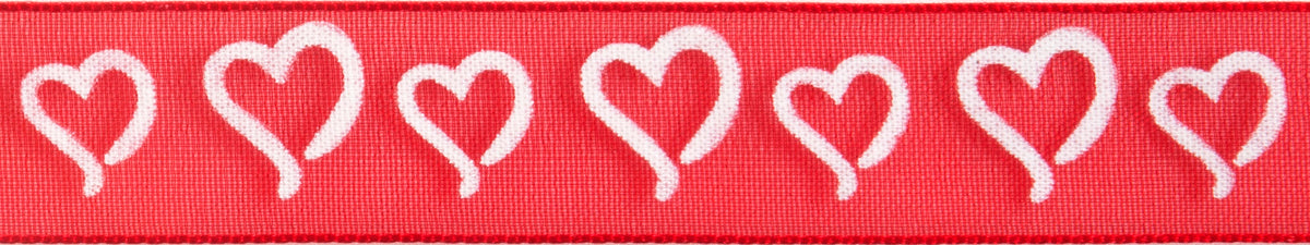 Reel of white on red ribbon printed with curly hearts