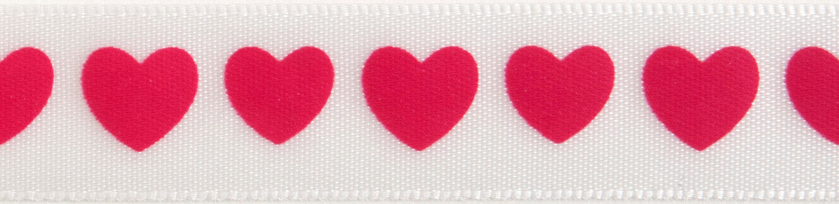 Reel of narrow white satin ribbon printed with hot pink hearts