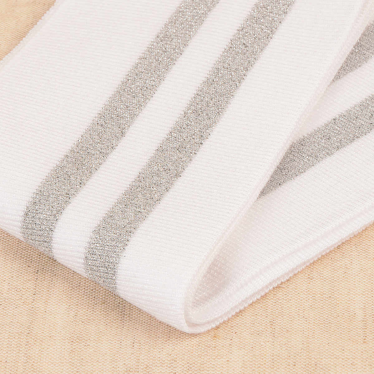 White cuff and waistband trim with silver metallic stripes