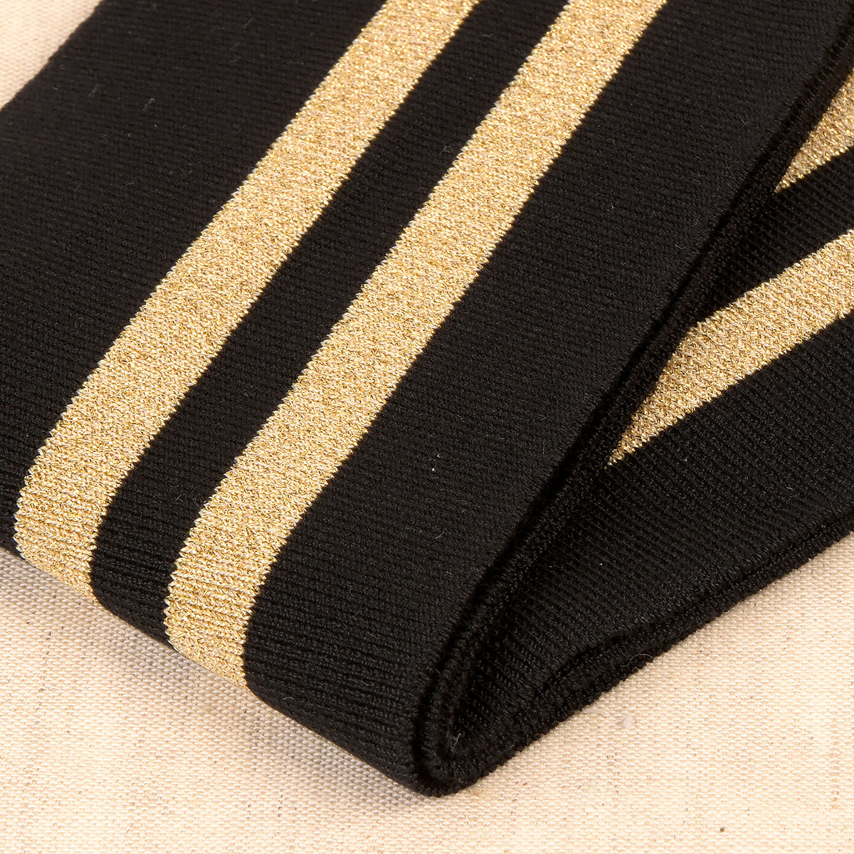 Black cuff and waistband trim with two gold metallic stripes