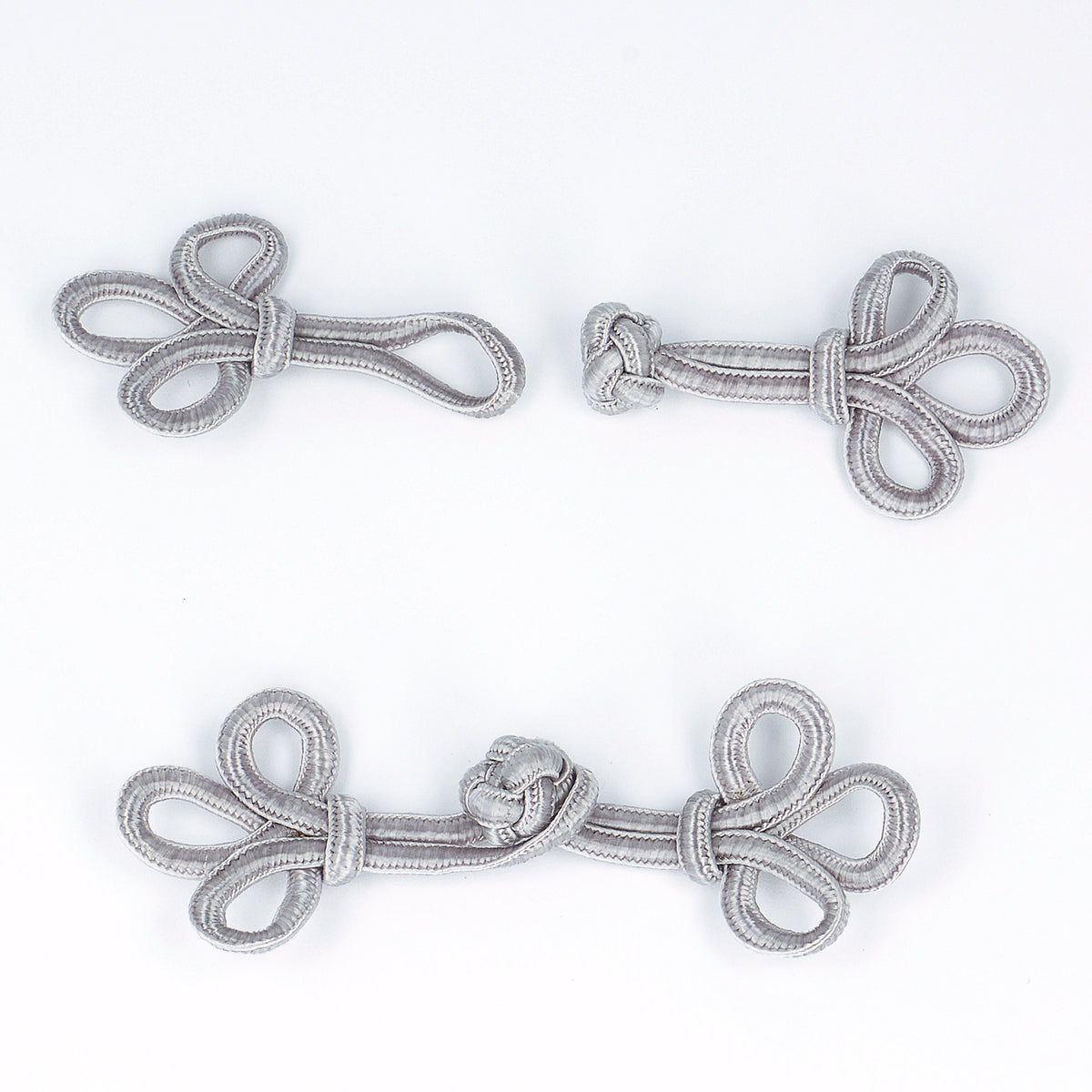 Grey knotted cord frog clasp fastening with loop and knot