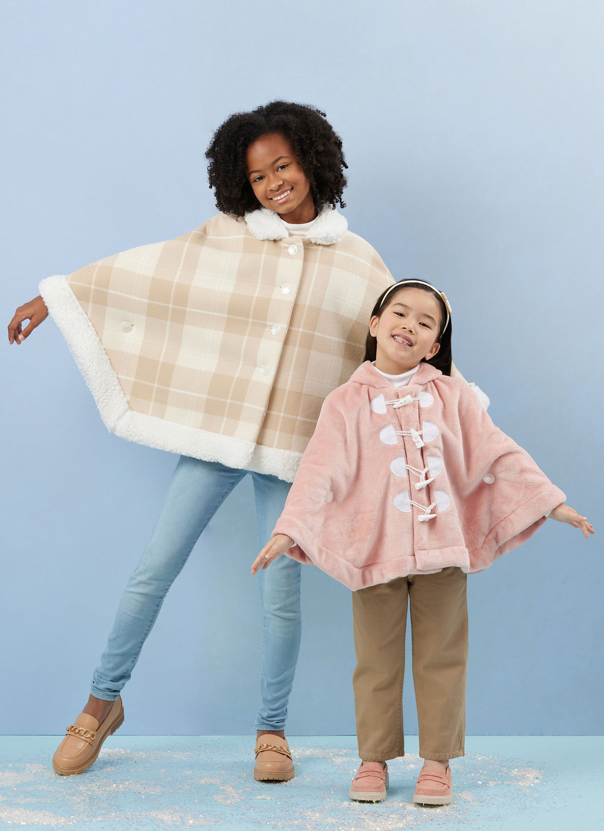 Simplicity S3043 sewing pattern envelope showing girls' poncho designs
