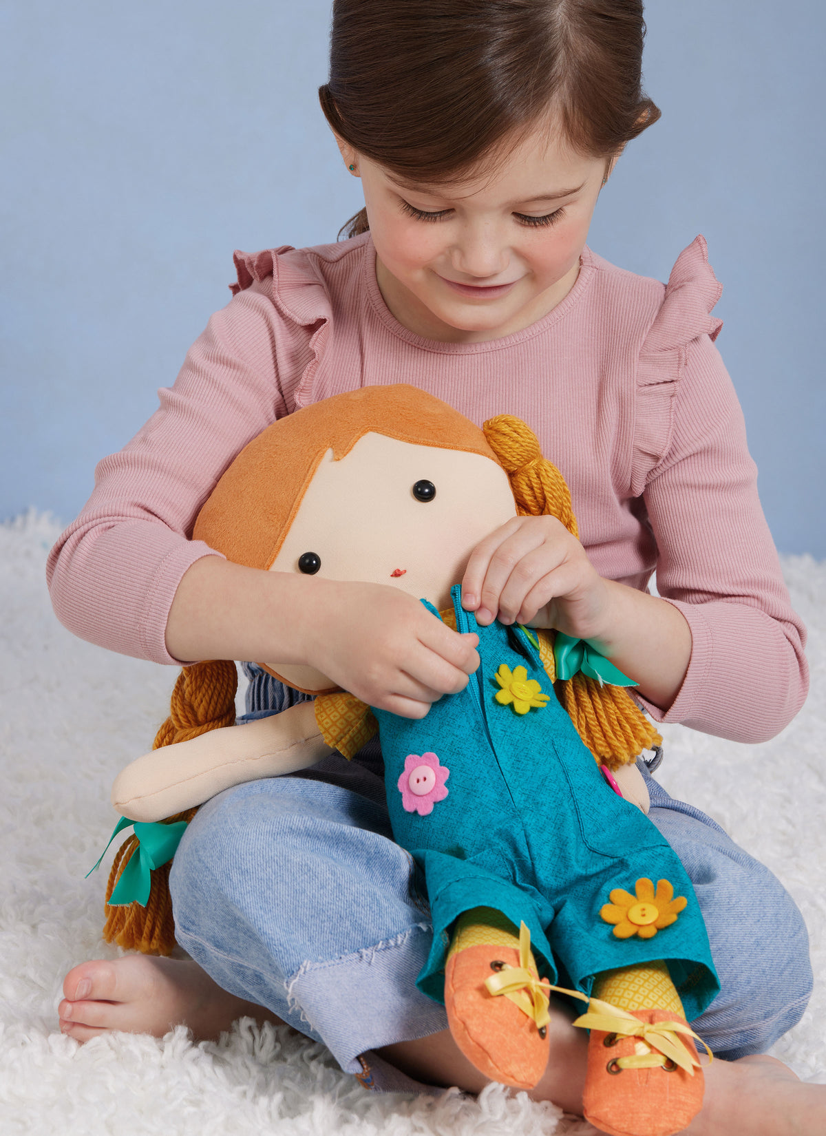 Simplicity S3053 sewing pattern envelope showing stuffed dolls with a choice of hair styles