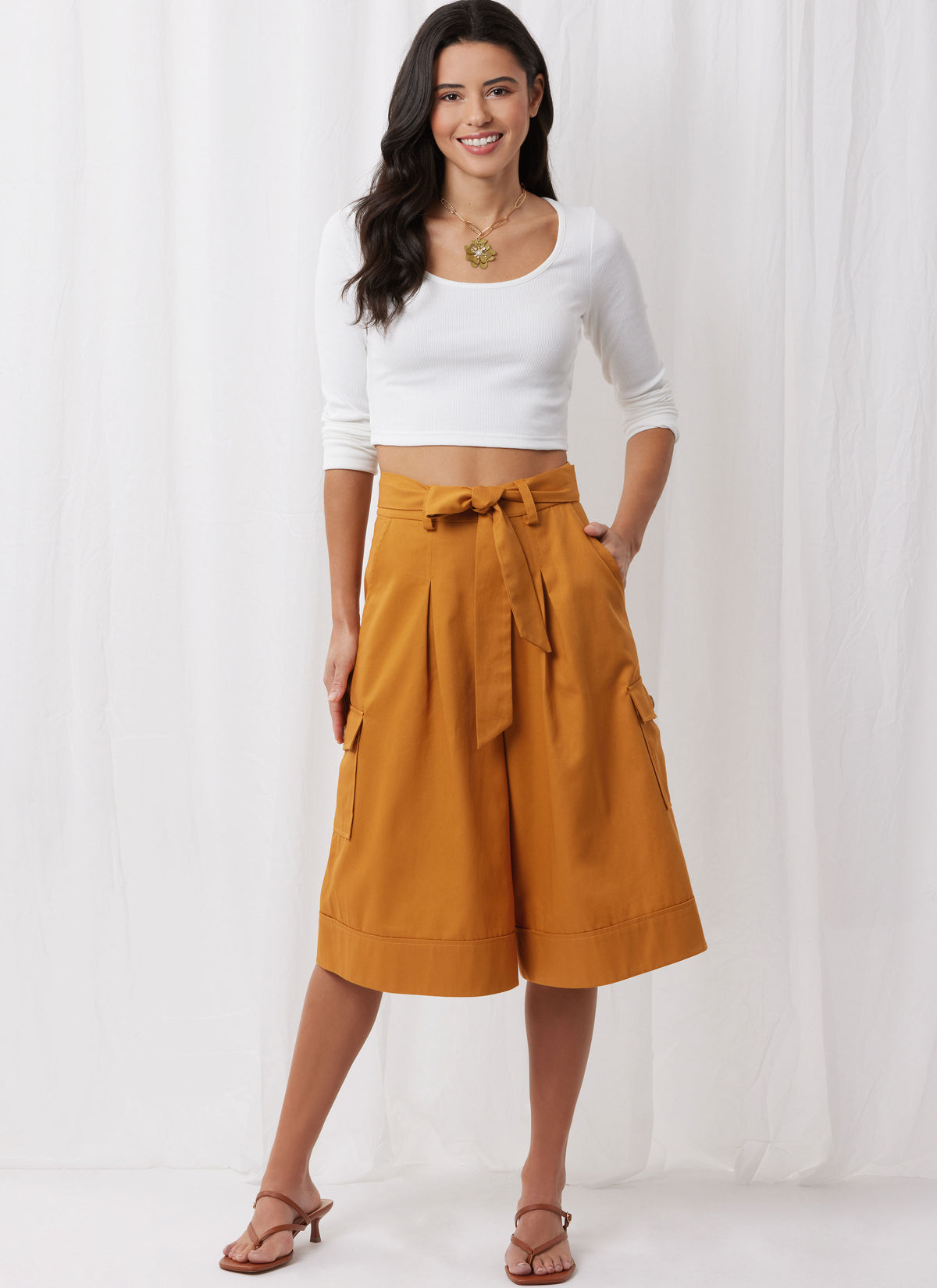 Simplicity S3106 pattern envelope showing a woman wearing a pleated skirt and trousers