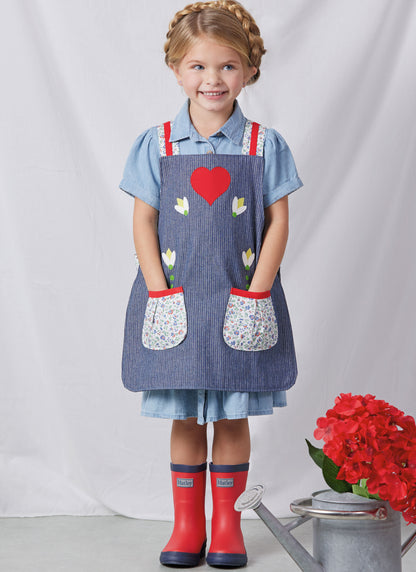 Simplicity S3119 pattern envelope showing aprons with contrast straps and floral appliques
