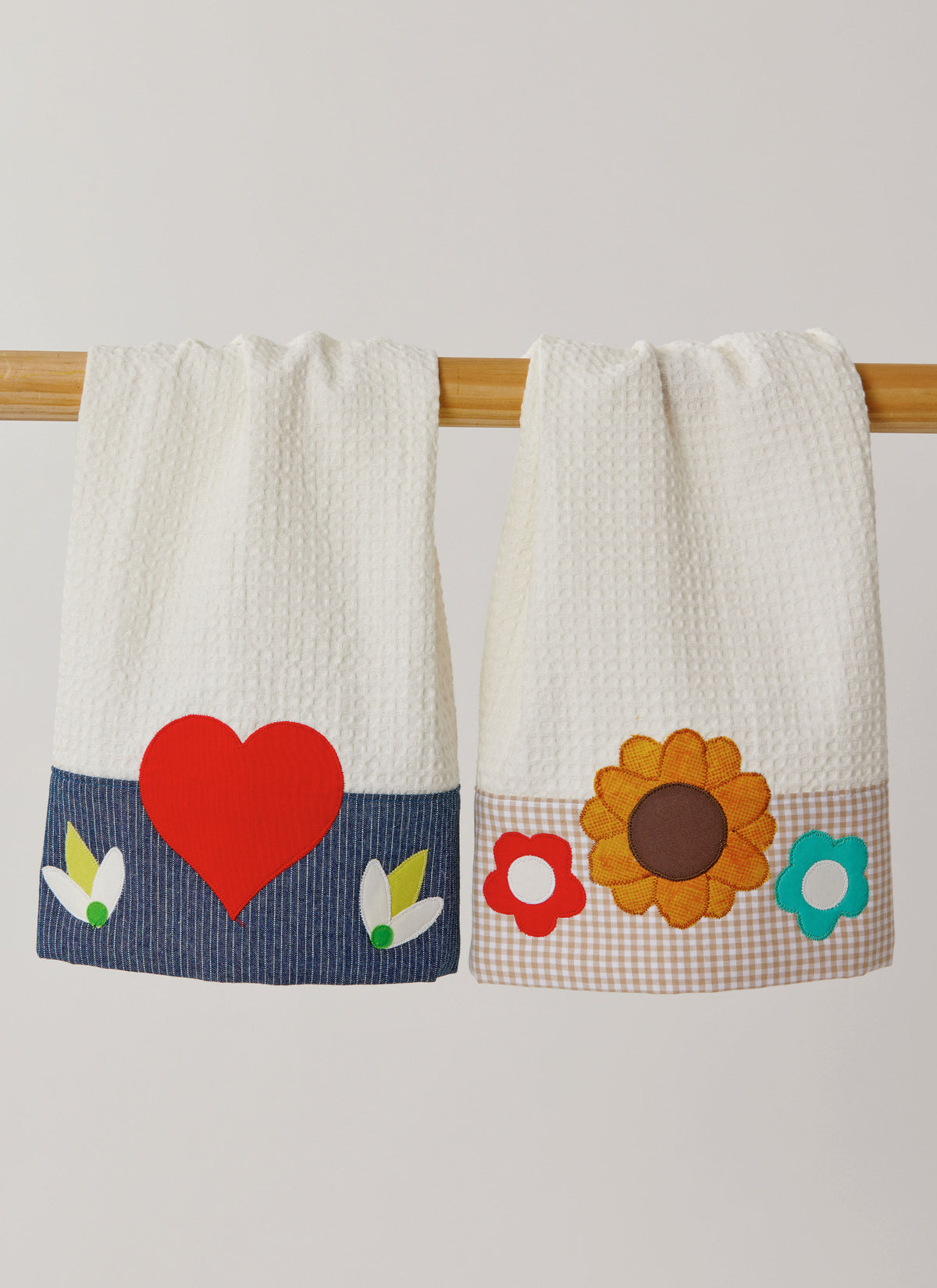 Simplicity S3119 pattern envelope showing aprons with contrast straps and floral appliques